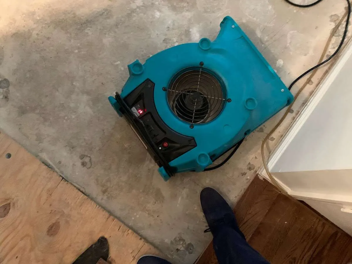 Air mover drying subfloor during Commercial Water Damage Restoration in North Stonington